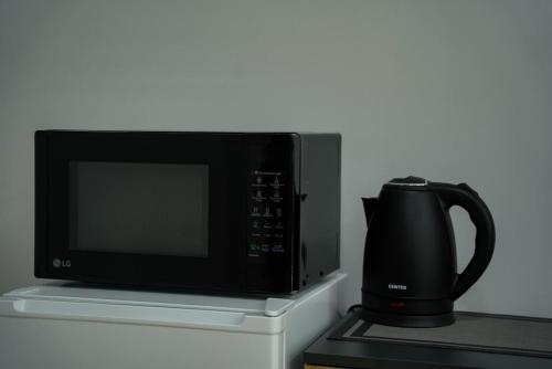 a microwave oven and a coffee pot on a counter at Square Inn in Gyumri