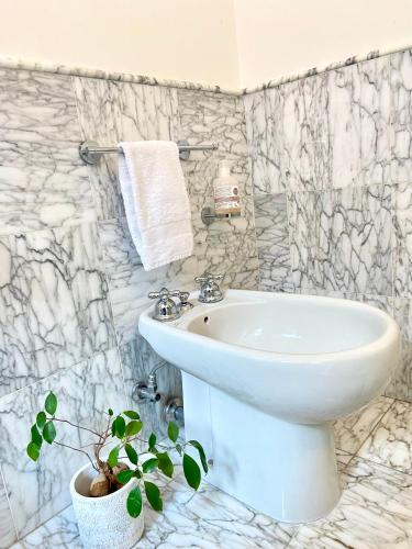 a white bathroom with a sink and a toilet at Miami in Venice in Venice