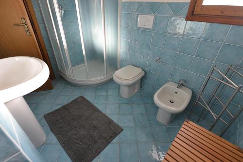 馬爾恰納馬里納的住宿－Sagittarius 1，蓝色瓷砖浴室设有卫生间和水槽