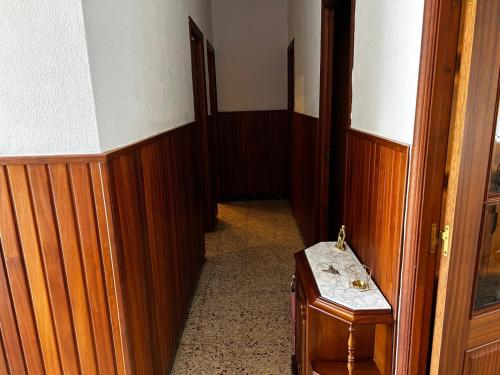 a hallway with wooden walls and a wooden door at CASA DE LA NIÑA,Chalet familiar con gran terraza in Fisterra