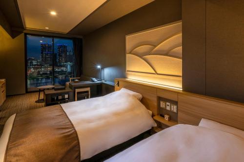 a hotel room with two beds and a window at La Vista Tokyo Bay in Tokyo