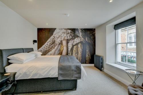 a bedroom with a bed with a large painting on the wall at 48 Swain Street, Watchet in Watchet