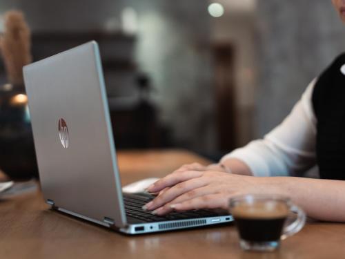 a woman sitting at a table using a laptop computer at Boutique Nest in New Cairo in Cairo