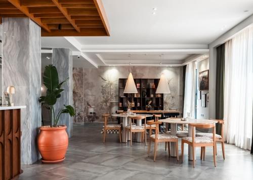 a dining room with wooden tables and chairs at Boutique Nest in New Cairo in Cairo