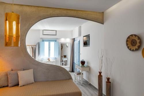 a bedroom with a bed with an archway at Light Blue Window Kamari in Kamari