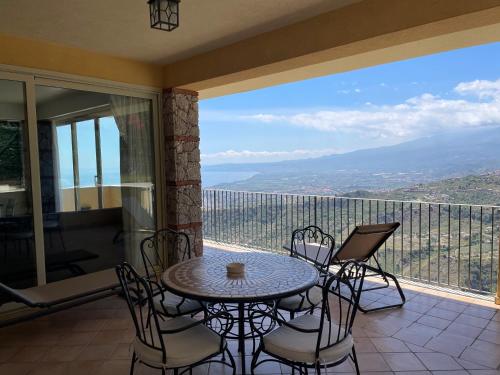 a patio with a table and chairs on a balcony at Villa Da Vinci Luxury Panoramic Apartments - Taormina rooms collection in Taormina