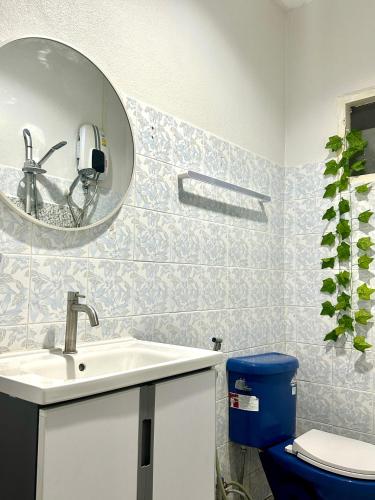 a bathroom with a sink and a mirror and a toilet at Bangtao Kitchen Studio in Bang Tao Beach