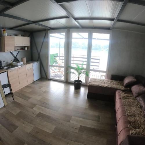 a large living room with a couch and a kitchen at Splav ostruznica in Belgrade