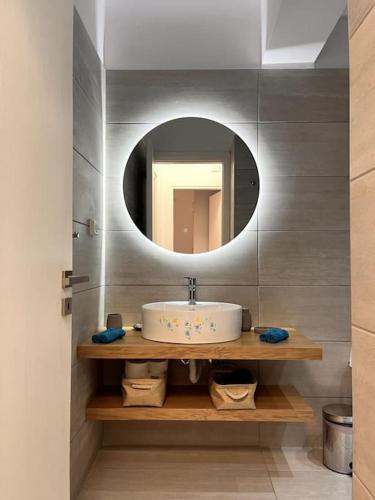 a bathroom with a sink and a mirror at Endless Bleu Villa Andros Island in Apróvaton
