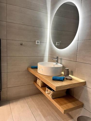 a bathroom with a sink and a mirror at Endless Bleu Villa Andros Island in Apróvaton