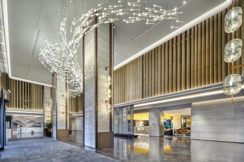 a lobby of a building with lights on the ceiling at Crowne Plaza Xi'an Weiyang, an IHG Hotel in Xi'an