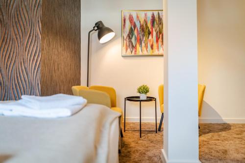 a hotel room with a bed and a table and chairs at Rezidencia Levočský Pivovar in Levoča