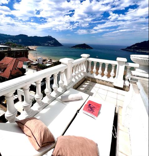 a balcony with a view of the ocean at Far Out Inn in Donostia-San Sebastián