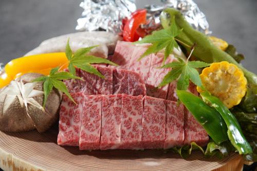 a plate of food with meat and vegetables on it at PrivateVilla8 in Minamiawaji