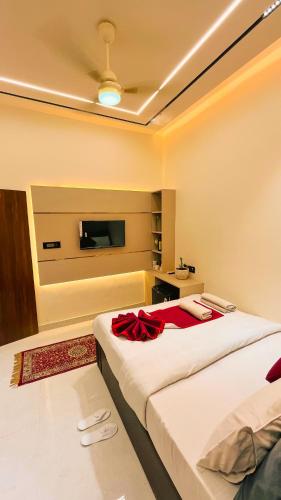a bedroom with two beds and a flat screen tv at The Vacation Villa in Agra