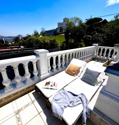 a bed on the balcony of a building at Far Out Inn in Donostia-San Sebastián