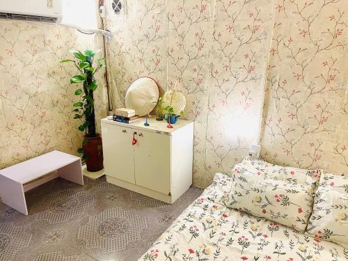 a small room with a bed and a mirror at Mika Homestay Simple & Cozy in Hanoi