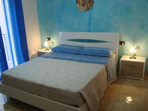 Le Tre Rose di Maria في نوتو: غرفة نوم بسرير كبير مع مواقف ليلتين