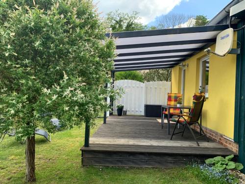 un porche de una casa con terraza de madera en Gästehaus A+C Bovet en Wesenberg