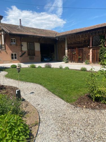 a house with a driveway leading to a yard at Les chambres de la Villa Oberlin in Beblenheim