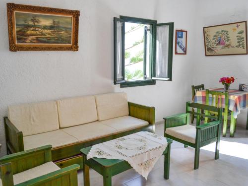 a living room with a couch and chairs and a table at Hotel Finiki View in Foinikion
