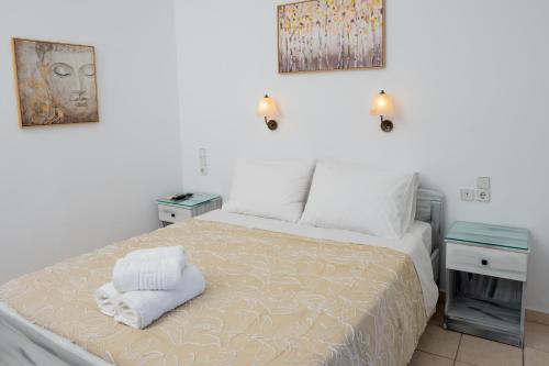 a bedroom with a bed with two towels on it at ARTEMIS beach studios in Kalamaki Heraklion