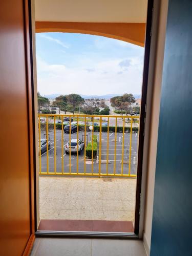a view from a window of a parking lot at appartement vue mer,accès direct plage,fibre,clim,parking public gratuit in Le Barcarès