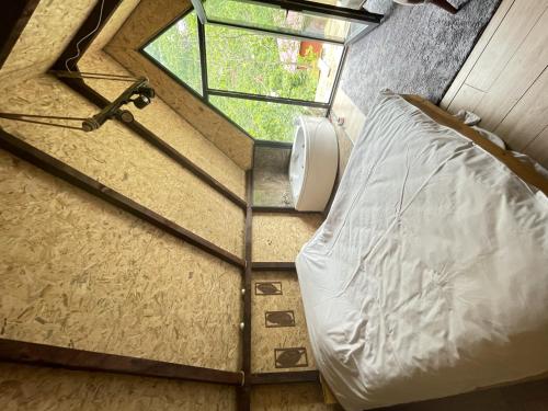 a small bedroom with a bed and a window at Riverside house in Akcaabat