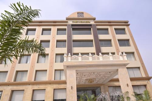 a building with a clock on top of it at The Velvista Hotel in Muzaffarnagar