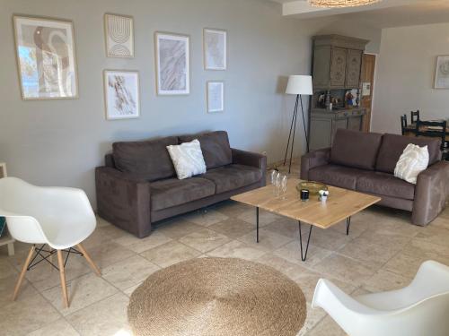 a living room with two couches and a coffee table at Les Mas d'Azur Appartement in Vence