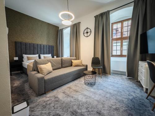 a living room with a couch and a bed at Rezidencia Levočský Pivovar in Levoča
