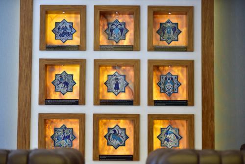 a group of eight paintings of stars in wooden frames at Giritligil Hotel in Manisa