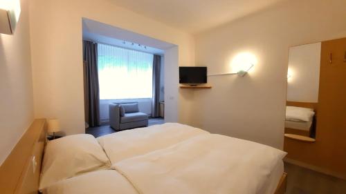 Hotel Promenade tesisinde bir odada yatak veya yataklar
