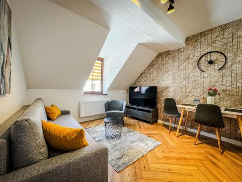 a living room with a couch and a table at Rezidencia Levočský Pivovar in Levoča