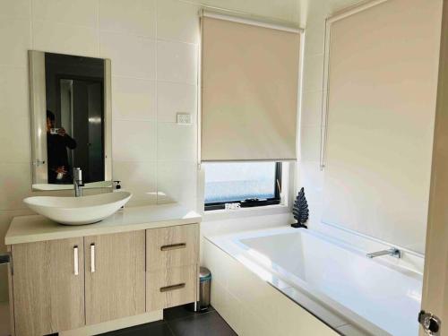 a white bathroom with a sink and a tub at D110 Sweet Melon super stay-fantastic in Braybrook