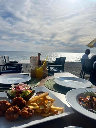 a table with plates of food on the beach at Ulu Panorama Residence in Alanya