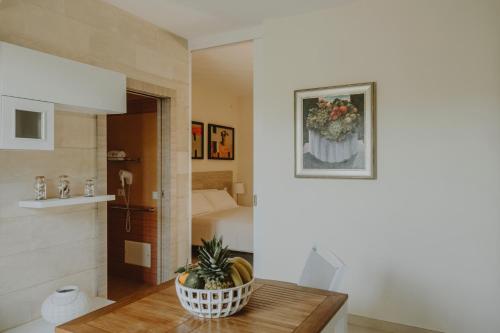 a room with a table with a plant on it at Villa Patrizia Salento Art & Room in Porto Cesareo