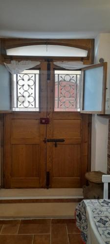 a large wooden door with two windows in a room at Appartamento Centro Storico Fondi in Fondi