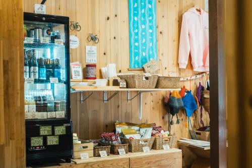 a store with a shelf of products and baskets at Raicho Onsen Inn in Matsumoto
