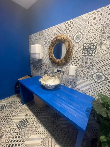 a bathroom with a blue bench and a mirror at Ne parliamo Stasera in Porto Santo Stefano