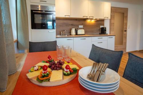 a table with a plate of food on top of it at Ferienwohnung Hüttenschnauzer in Pfronten