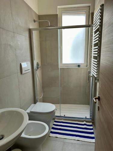a bathroom with a shower and a toilet and a sink at Maris Apartment by Tenuta Pinto in Mola di Bari