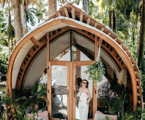 Una mujer con un vestido de novia parada en una sala redonda en Hotel Lion Sands Masai Mara Lodge en Masai Mara