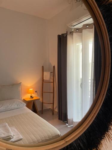 a bedroom with a bed and a mirror at Asteras in Antiparos Town