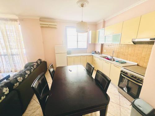 a kitchen with a table and chairs in a room at Lovely 3-bedroom rental unit in Durrës in Durrës