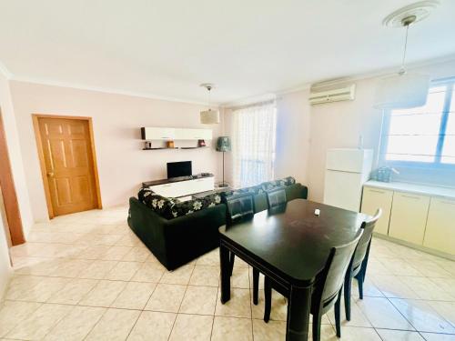 a living room with a couch and a table at Lovely 3-bedroom rental unit in Durrës in Durrës