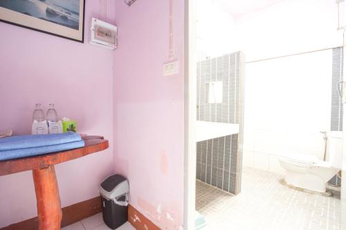 a bathroom with a sink and a toilet in it at Greenhouse resort in Buriram