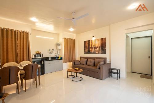 a living room with a couch and a table at Advika Homes in Kolhapur