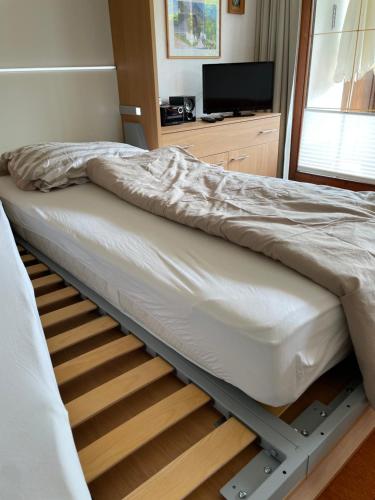 a bed on a bed frame in a room at Ferienwohnung Niklas inklusive Bad Hindelang Plus in Bad Hindelang