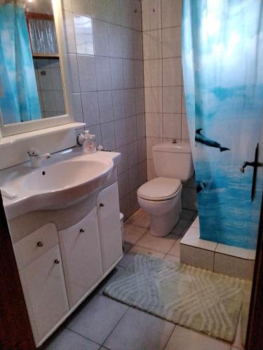 a bathroom with a sink and a toilet and a shower at Lambrinis house in Kanallákion